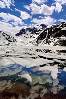 Ice floes float in the half-frozen Upper Murgsee, Murgtal, Canton of St. Gallen, Switzerland