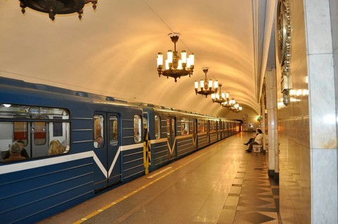 A train in a quiet subway station with ornate lights on the ceiling, metro, Saint Petersburg, St.