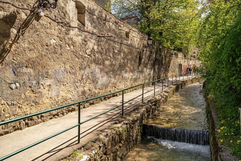 City wall and promenade on the Cheu river in Brasov or Kronstadt, Transylvania, Romania