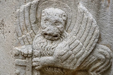 A carving of Saint Mark's winged lion, a Venetian symbol, dated 1475, on a well in the old town,