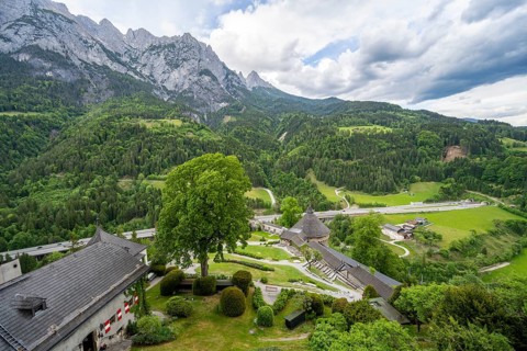 View of the Lower Castle courtyard with castle wall, mountain peaks of the Tennengebirge Mountains,