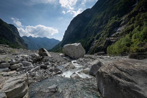 Large boulders lie in the Bavona River riverbed as a result of heavy rock and debris flow on the