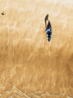 Top Down view fo woman with kayak over Beach from a drone, North Devon and Cornwall Coastpath