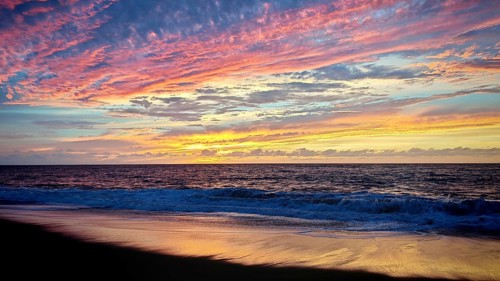 A colorful sunset over a quiet beach with gentle waves, Cabo Verde, Tarrafal de Monte Trigo, Santo