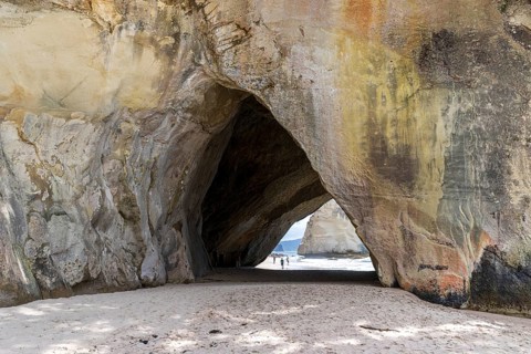 The iconic Mautohe Cathedral Cove, a gigantic arched cavern that passes through a rock headland to