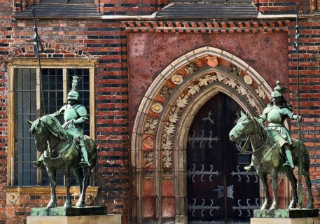 Heralds and southeast portal with Gothic sandstone walls at Bremen City Hall, important brick