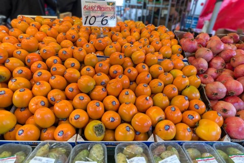 Persimmons (Diospyros kaki) at a weekly market market, the Netherlands