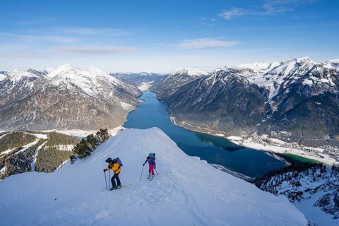 View of Achensee and wintry mountain scenery, ski tourers climbing to Bärenkopf, Achensee, Tyrol,