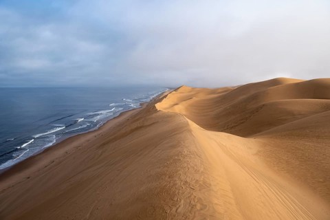 Sand dunes and sea in the morning, Atlantic coast and sandy desert with sea of dunes, Sandwich