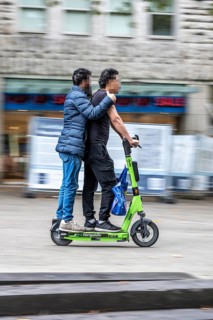 E-scooter in the city center of Essen, people ride in pairs on the electric scooter, is prohibited,