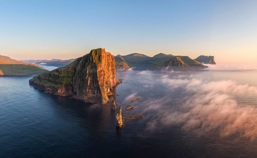 The Risin og Kellingin pinnacles off the Eysturoy cliffs in the evening light, Faroe Islands,