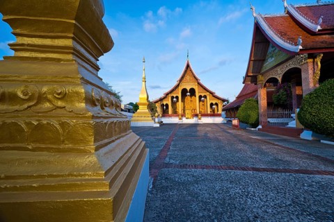 Sunrise, morning atmosphere at Wat Sibounheuang Buddhist monastery, Luang Prabang, Laos, Southeast