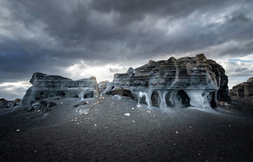 Eroded rock formations, volcanic landscape with dramatic cloudy skies, Ciudad Estratificada or Los