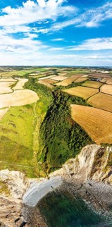 Cliffs and Farms over North Devon and Cornwall Coastpath Border from a drone, Welcombe Mouth Beach,