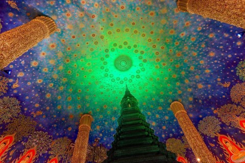 In the emerald green silence of Wat Paknam Phasi Charoen, the glass chedi rises like a glowing
