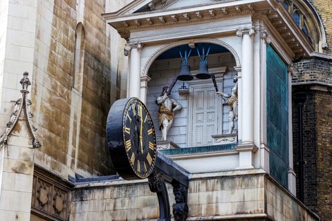 The projecting clock of St Dunstan-in-the-West stands out against the church tower and neighbouring