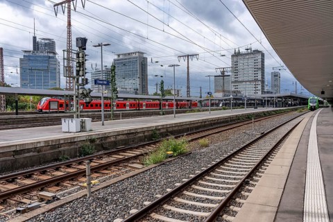 Regional train in Essen main station, downtown skyline, high-rise office buildings, North