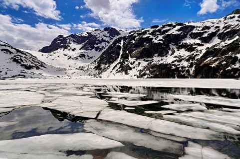 Ice floes float in the half-frozen Upper Murgsee, Murgtal, Canton of St. Gallen, Switzerland