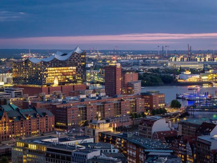View of the illuminated Elbe Philharmonic Hall, HafenCity and the Port of Hamburg at the Blue Hour,