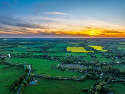 Sunset of Fields and Farms over Horsebridge nad Stockbridge from a drone, Hampshire, England,