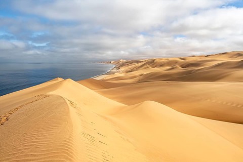 Sand dunes and sea, Atlantic coast and sandy desert with sea of dunes, Sandwich Harbour, Namib