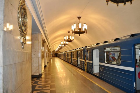 Underground subway station with a blue train and decorative hanging lamps, Metro, Saint Petersburg,