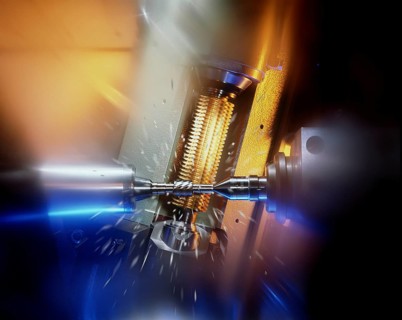 CNC controlled gear hobbing machine precisely machining a metal gear with cutting tool, flying