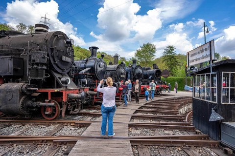 Ring locomotive shed with many historic steam locomotives in the Bochum Railway Museum, museum days