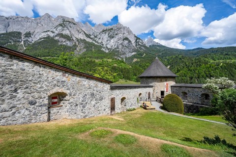Tower on the castle wall, Hohenwerfen Fortress, rocky peaks of the Tennengebirge Mountains in the