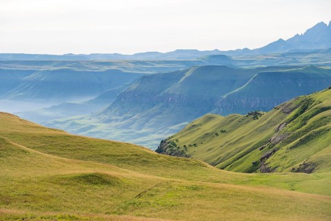 Green fields and mountains, cathedral range mountainous landscape, Drakensberg Mountains,