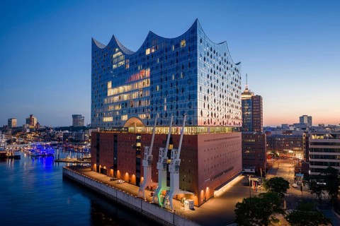 Aerial view of sunrise on the Elbe with Elbe Philharmonic Hall and reflections in the glass façade,