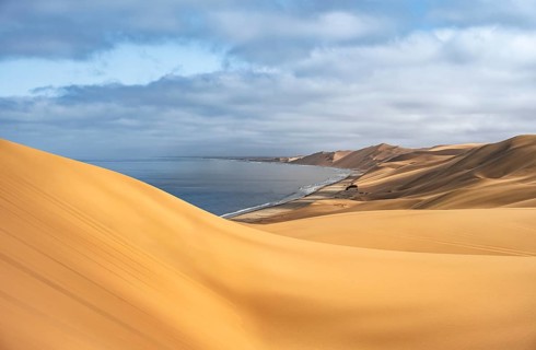 Sand dunes and sea in morning light, Atlantic coast and sandy desert with sea of dunes, Sandwich