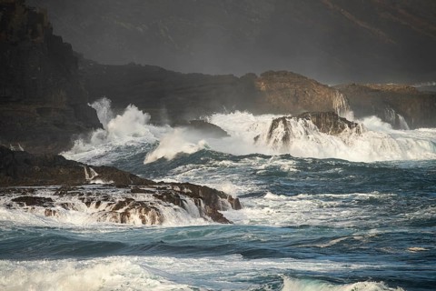 Wild sea and high waves on the coast at the La Fajana marine swimming pool. Morning light. La