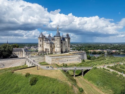 Aerial view of the historic Château de Saumur with its distinctive round corner towers and bright