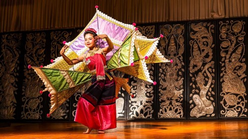 Young Thai woman with fan-like wings showing a traditional dance, Old Chiang Mai Cultural Center,