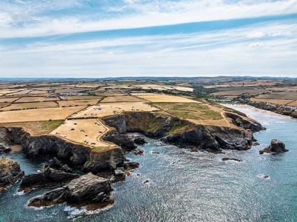 Farms and Fields over Cliffs and Porthcothan Bay from a drone, Porthcothan, Padstow, Cornwall,