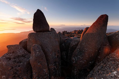 Glowing red sunrise over Mt. Wellington near Hobart. Sea of rocks on the summit