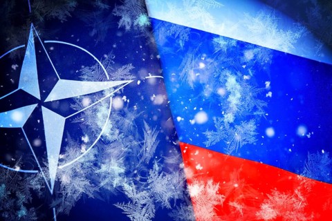 NATO and Russian flags with ice crystals and snow, symbolic photo of the standstill of the Ukraine