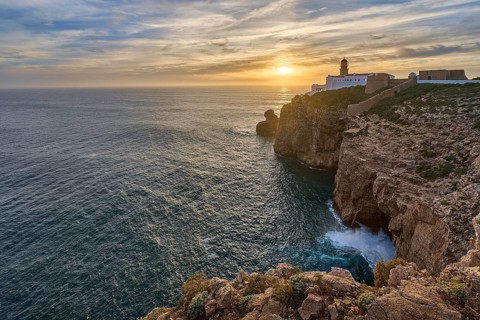 Moody view on Cabo Sao Vicente with its famous lighthouse at sunset at the south.estern spit of