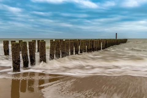 Coastal protection, through wooden posts, paalhoofden, on the beach, breakwater, the piles, some of