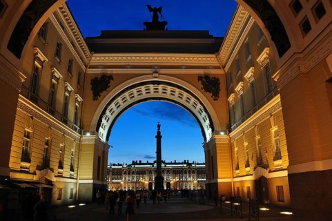 Impressive, illuminated archway with view of a colonnade at dusk, General Staff Building, Saint