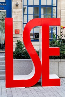 A large red LSE sign stands outside the London School of Economics on Portugal Street. Founded in