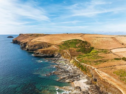 View of Pentire Point and Bay over Padstow Bay from a drone, Polzeath, Cornwall, England, Summer