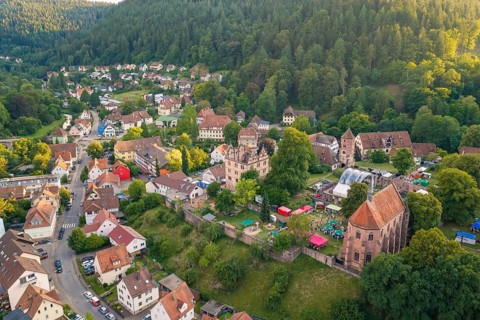 Village with historic buildings and hills in the middle of a forest in sunny weather, Calwer