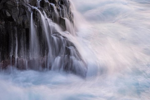 Lava rocks in the ocean, washed by waves. Charco Verde, La Palma, Canary Islands, Spain