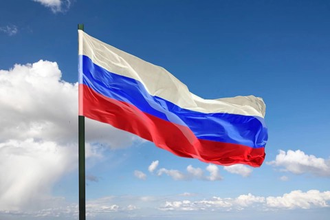 (Photo montage) Flag of Russia against blue sky