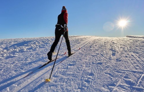 Sportive woman crosscountry skiing at sunset in the Bregenz Forest mountains, Sulzberg, Vorarlberg,