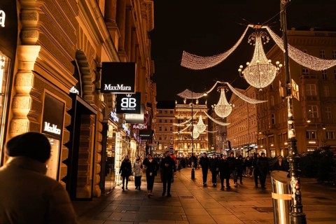 Vienna, Austria - 15 December, 2025: Busy street in Vienna, Austria, illuminated by festive lights.
