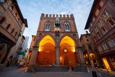 Illuminated historic Palazzo della Mercanzia, old town, Bologna, Emilia Romagna, Italy
