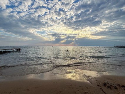 Sunset over the sea, broken cloud cover allows rays of light to fall on the water, Side, Manavgat,